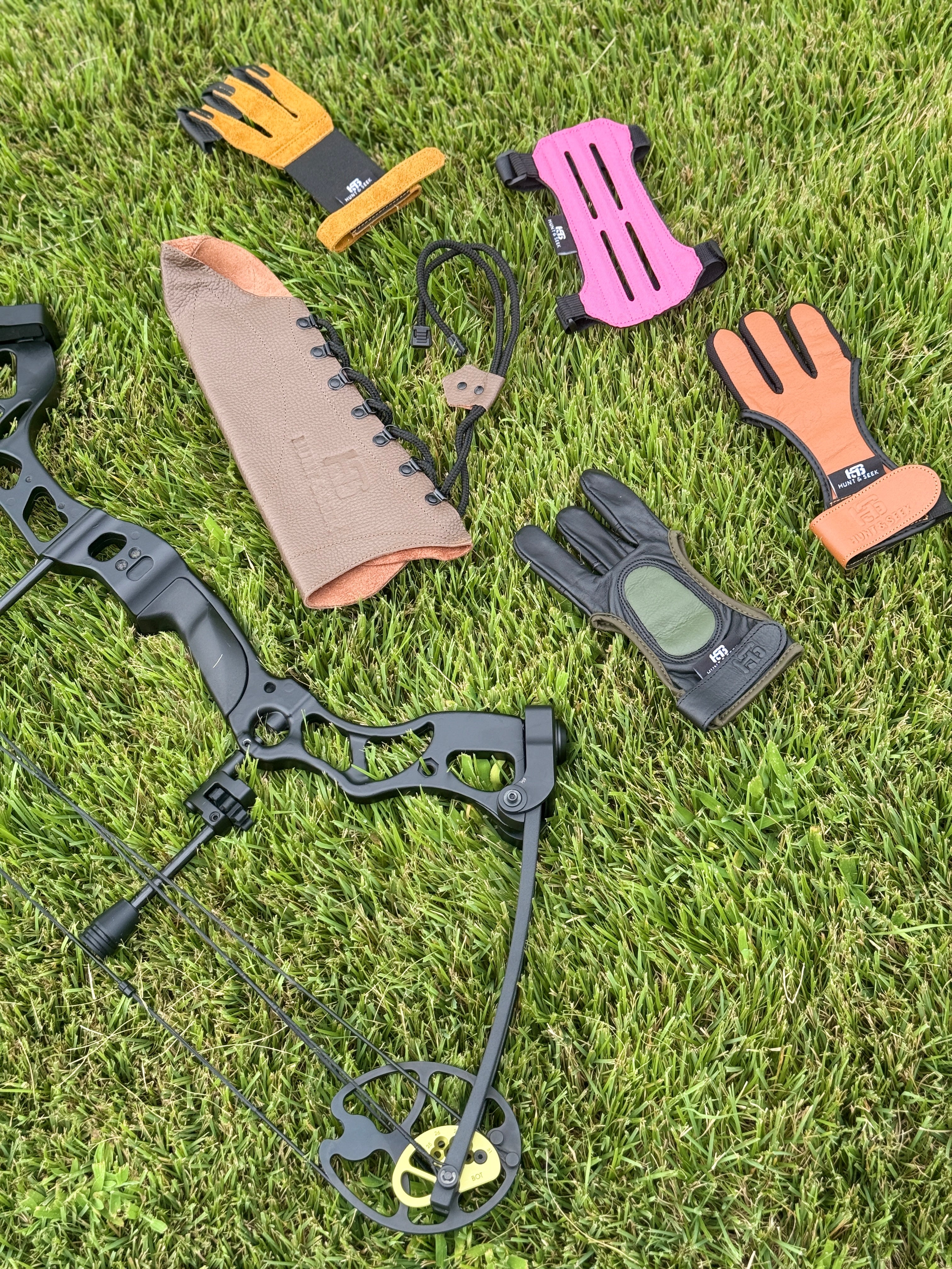 Compound bow and accessories on grass
